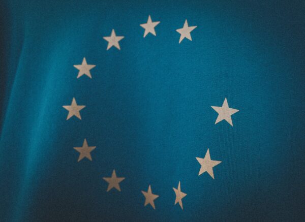 Background flag of the European Union. The flag is blu and the stars are a light yellow.